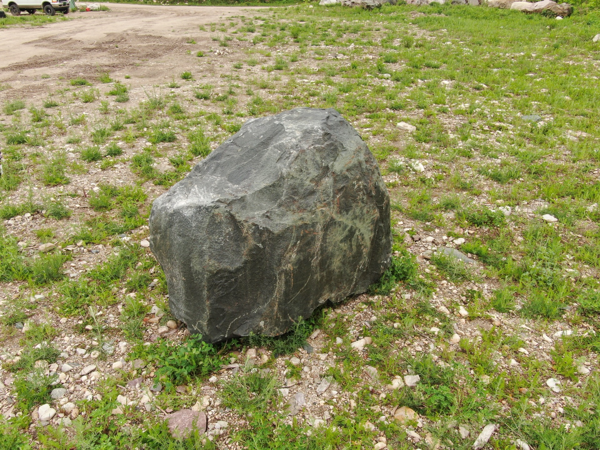 Dark granite character boulder at Stone Mountain quarry