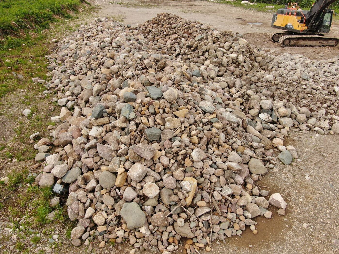 Large stockpile of rounded multicolored landscape cobbles