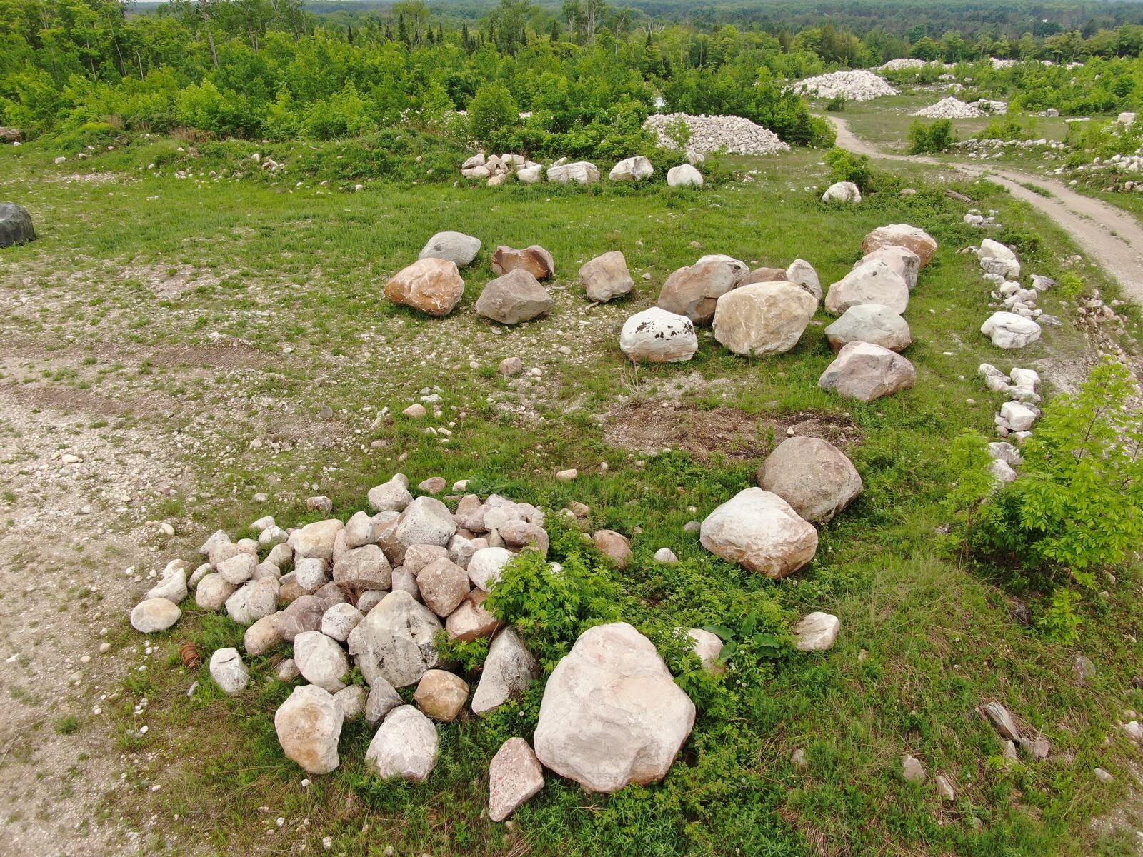 Aerial of large character boulders staged in the yard