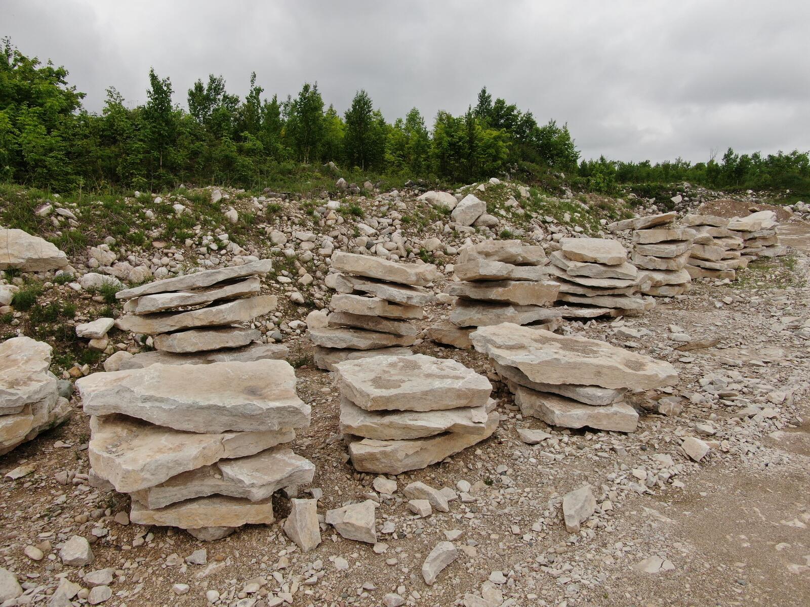 Rows of stacked limestone slabs along the stockpile