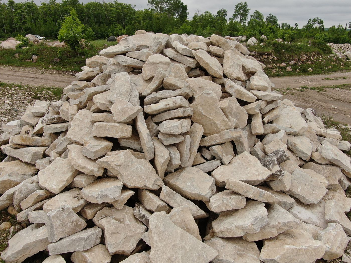 Large pile of flat irregular limestone pieces