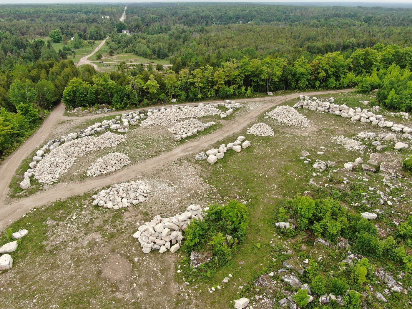 Aerial view of sorted stone piles across the quarry