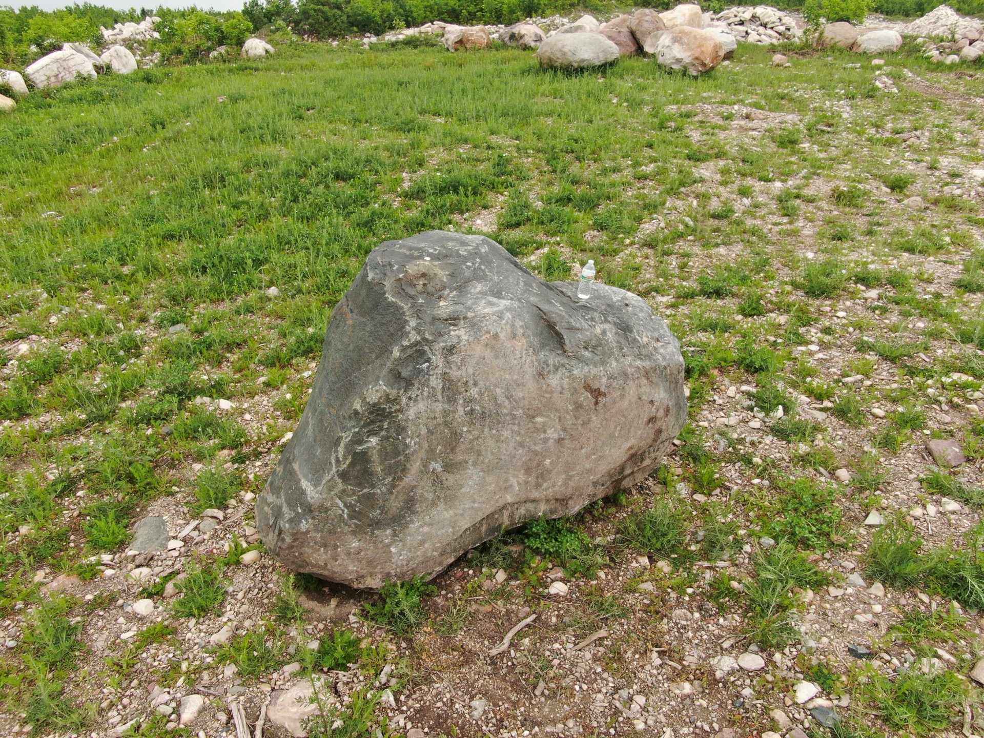 Quarry yard with boulders and equipment